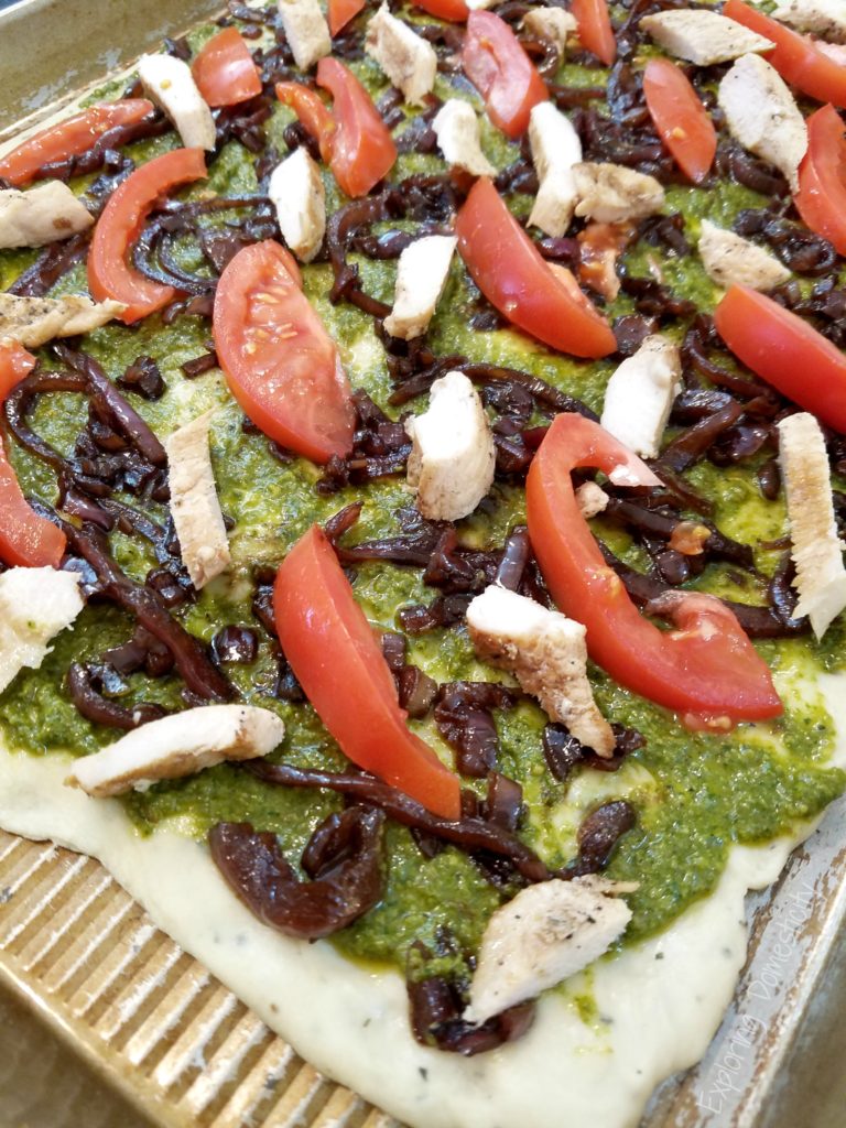 Balsamic Onion Pesto Pizza Assembly - pesto, onions, chicken, tomato, and cheese