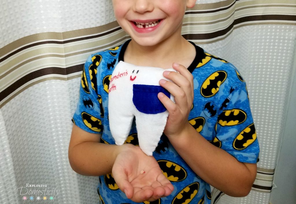 First tooth lost with his tooth fairy pillow