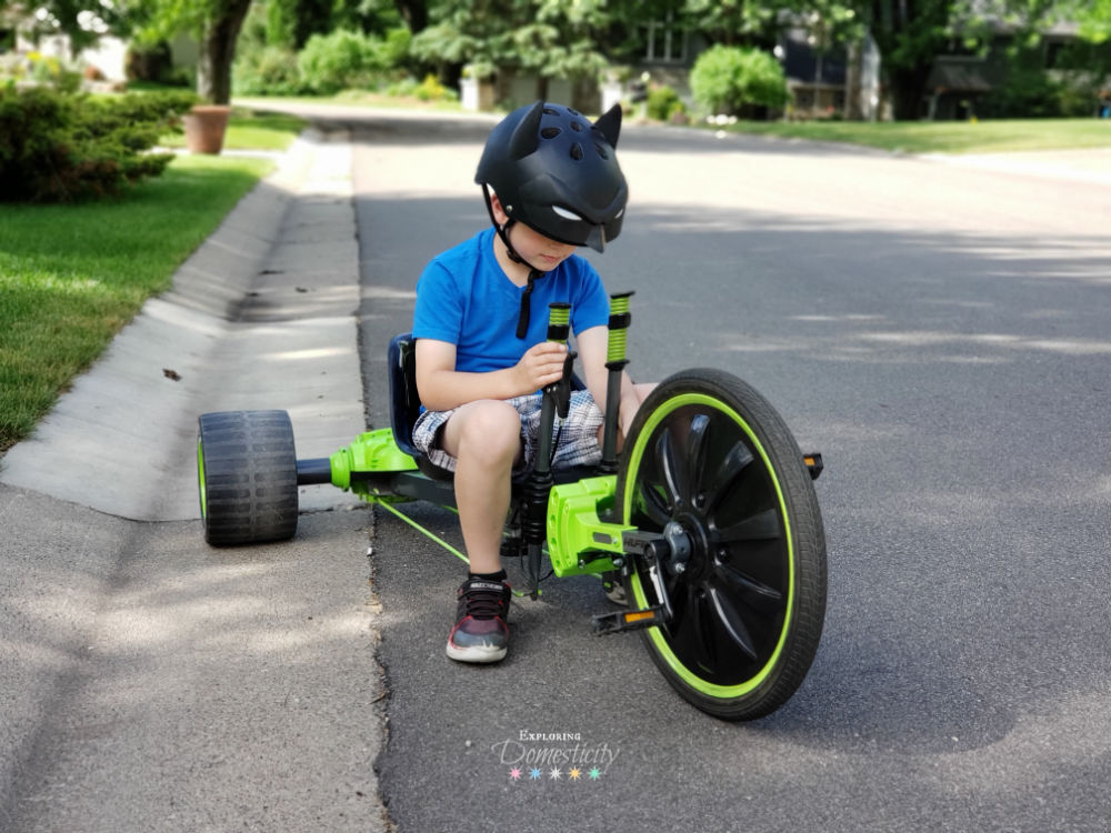 Boy riding Huffy Green Machine in Batman Bike Helmet