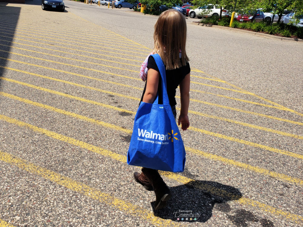 little girl with walmart bag in parking lot - shopping at Walmart for back to school snacks