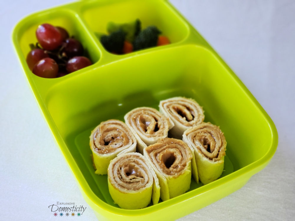 Peanut butter and honey pinwheel sandwich bento box with grapes and veggies