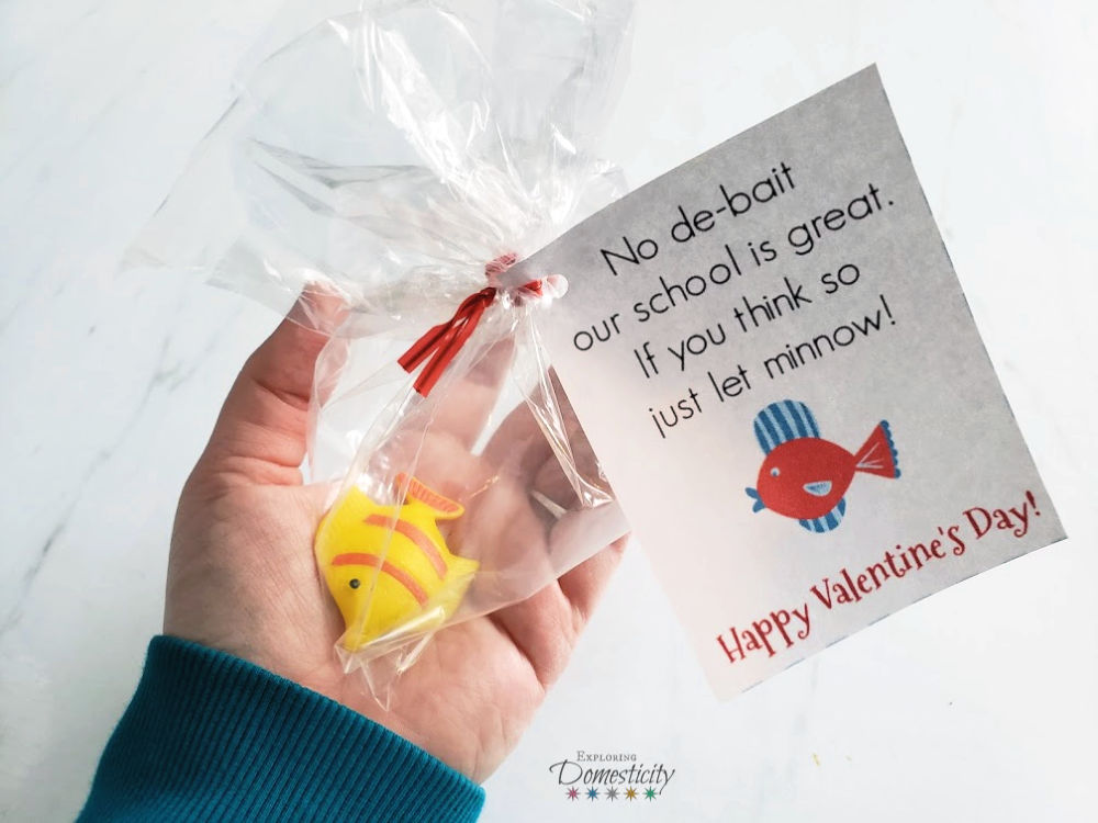 hand holding fish valentine with grow fish and printable card