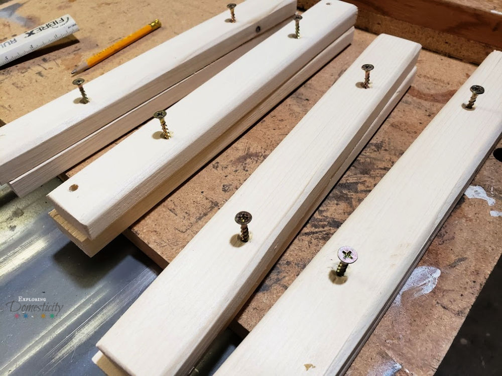 wood pieces with drilled holes for easy DIY picture frame