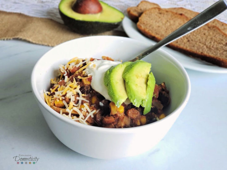 Chicken Chili with sour cream, cheese, and avocado