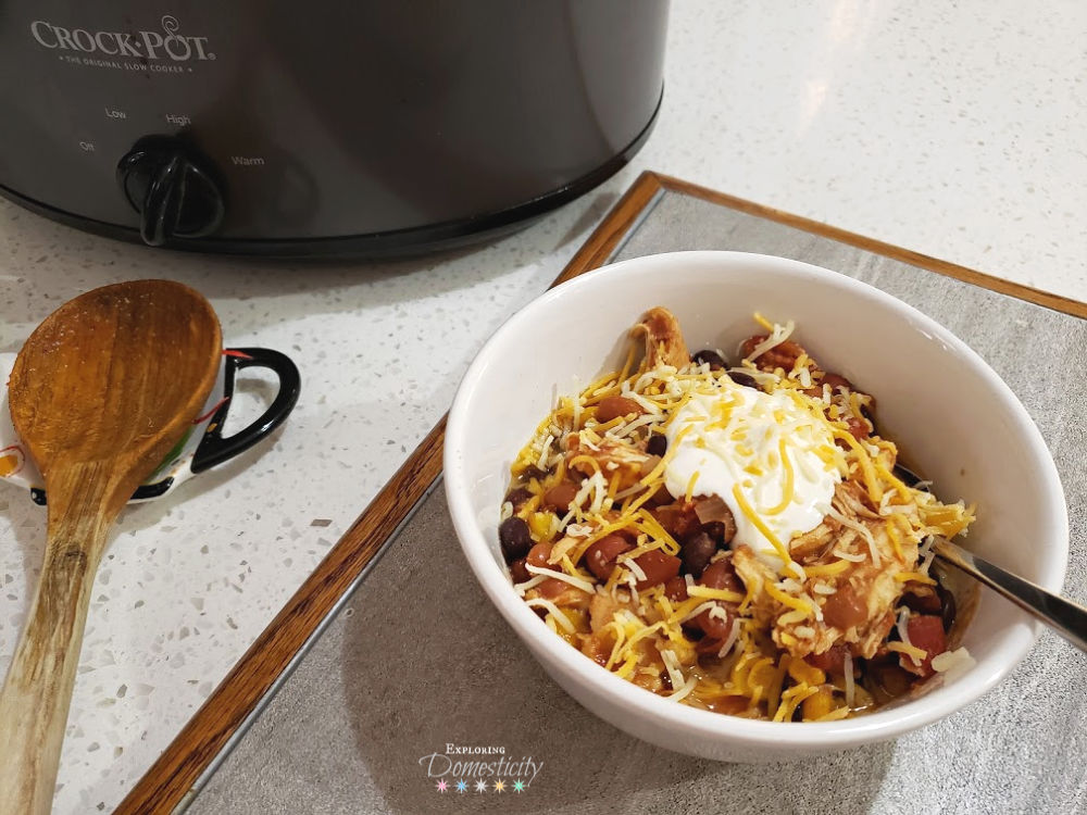 Crockpot Chicken Chili served in a bowl with cheese and sour cream