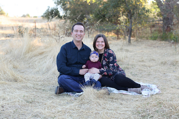 Mom, Dad, and baby in a field