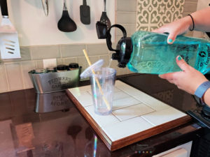 Pouring water from EnergyBud gallon jug